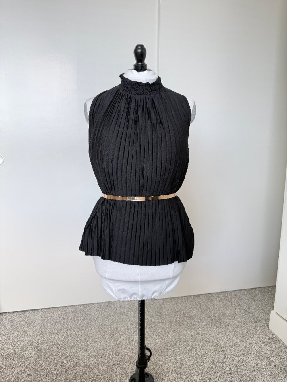 Black pleated sleeveless blouse